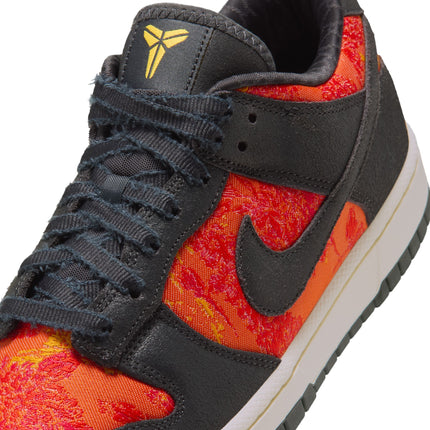 Close-up of a Nike Dunk Low Protro in anthracite suede with vibrant orange and yellow floral textile side panels.