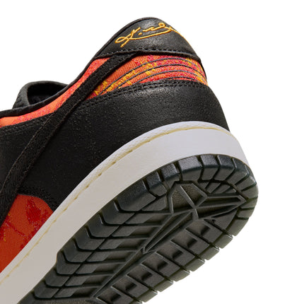 Rear view of a black suede and red patterned Nike Dunk Low Protro with a white midsole and black rubber outsole.