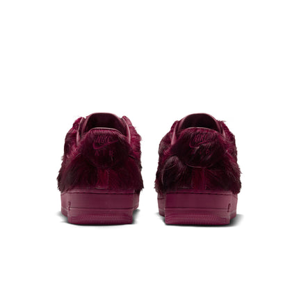 Rear view of Nike Air Force 1 sneakers in Team Red featuring a luxurious faux fur upper and tonal rubber soles.