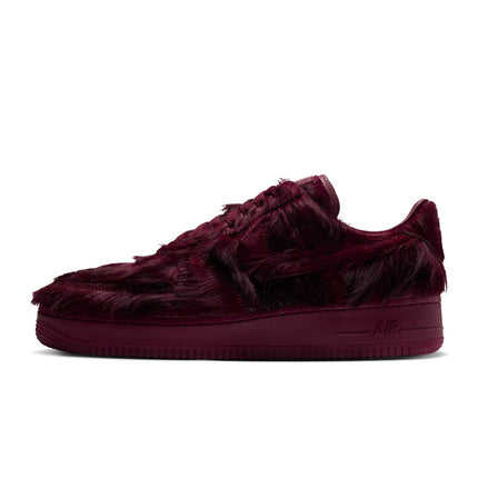 Nike Air Force 1 low-top sneaker in team red faux fur with a matching tonal midsole, shown from a side profile view.