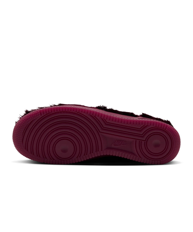 Bottom view of a Team Red Nike Air Force 1 sneaker featuring a deep burgundy rubber outsole and fuzzy textured upper.