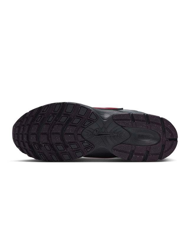 Bottom view of a Nike V5 RNR sneaker featuring a dark grey rubber outsole with red specks and a molded Nike logo.