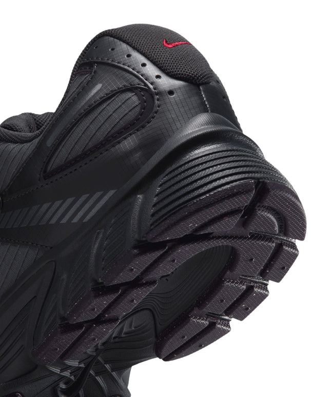 Close-up of the black and grey ripstop heel of a Nike V5 RNR shoe featuring a small red Swoosh logo and tread sole.