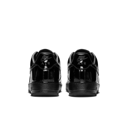 Rear view of Nike Air Force 1 '07 sneakers featuring a shiny, all-black patent leather finish and tonal black branding.