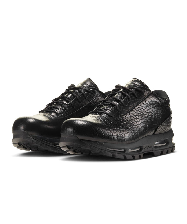 Black sneakers with white soles on a white background
