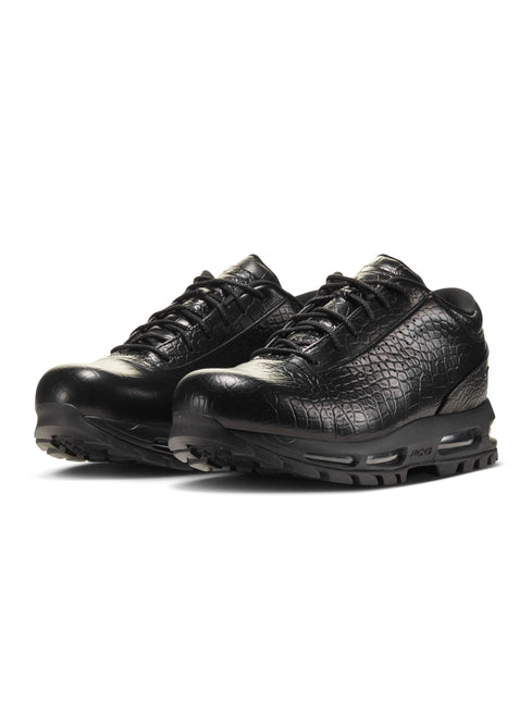 Black sneakers with white soles on a white background