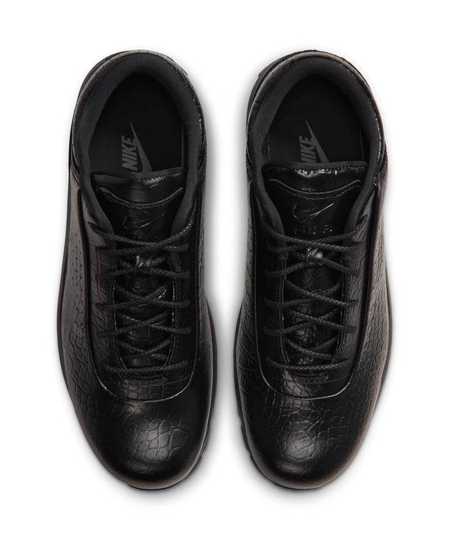 A pair of black Nike sneakers with a textured leather finish, shown from a top-down view on a white background.