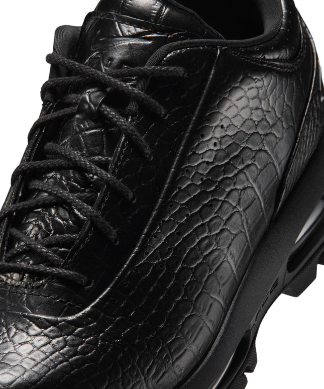 Close-up of a black Nike Air Max Goadome Low sneaker featuring crocodile-embossed leather, black laces and chunky sole.