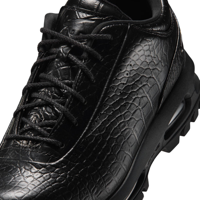 Close-up of a black Nike Air Max Goadome Low sneaker featuring crocodile-embossed leather, black laces and chunky sole.