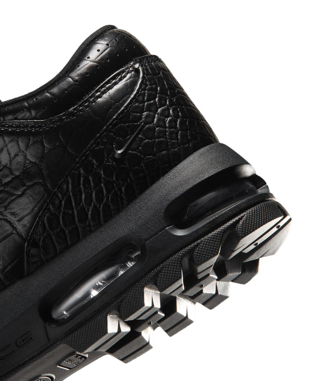 Black Nike Air Max Goadome Low sneaker heel featuring crocodile-textured leather, visible air cushioning, and lug sole.