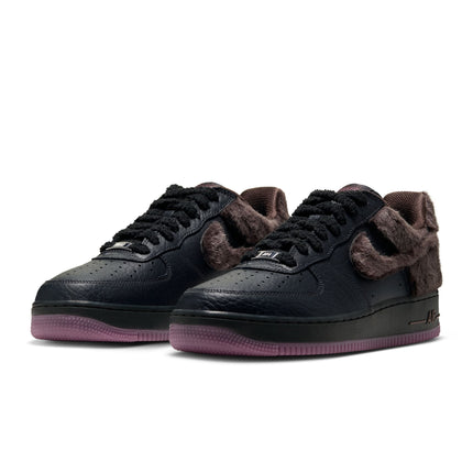 Nike Air Force 1 Low Retro sneakers featuring black tumbled leather, fuzzy brown faux fur panels, and purple outsoles.