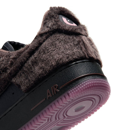 Close-up of Nike Air Force 1 Low shoe featuring brown faux fur upper, black midsole, and pink translucent outsole.
