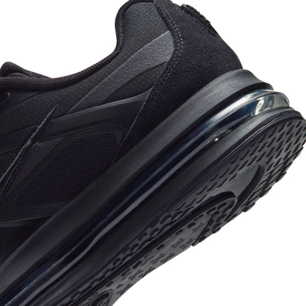 Close-up of a black Nike Air Max Metro sneaker showing the textured mesh upper, suede heel panel, and translucent sole.