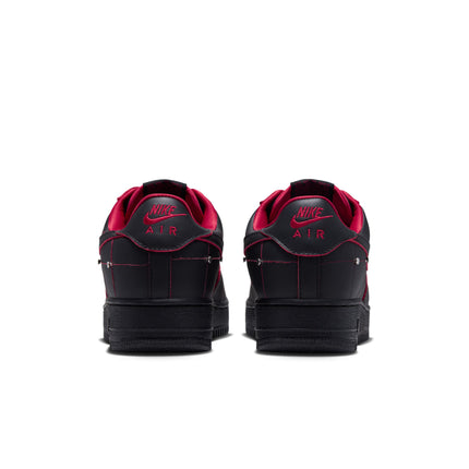 Back view of black leather Nike Air Force 1 sneakers with gym red lining, contrast stitching, and metallic details.