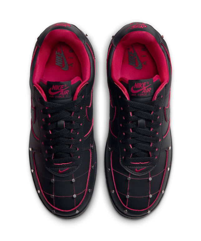 Top-down view of black Nike Air Force 1 sneakers with gym red piping, quilted leather detailing, and metallic silver studs.