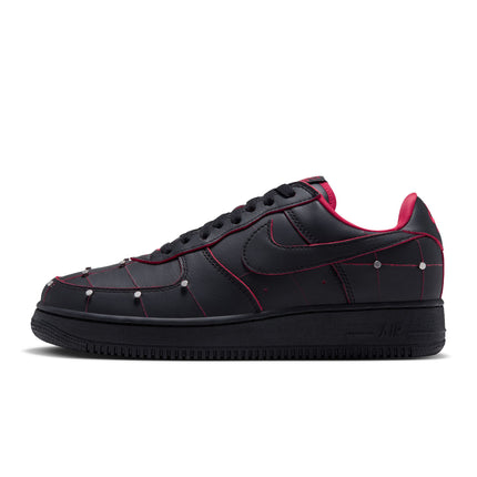Nike Air Force 1 low-top sneaker in black leather with gym red piping, metallic silver studs, and a black rubber sole.