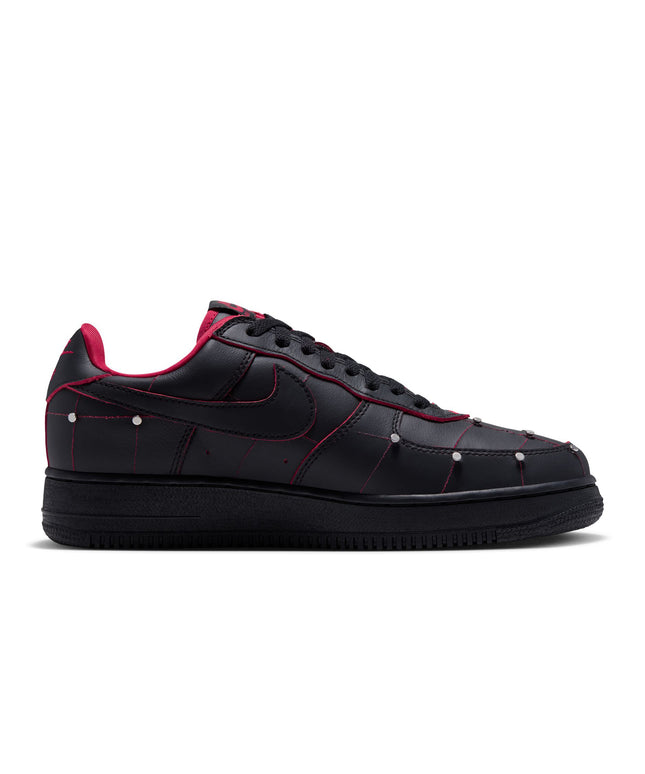Nike Air Force 1 low-top sneaker in black leather with gym red contrast stitching and metallic silver stud accents.