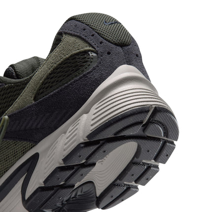 Close-up view of the heel of a Nike V5 RNR sneaker featuring olive green mesh, black suede overlays, and beige sole.