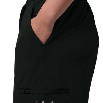 Side view of black Jordan Sport Dome shorts for women, featuring a zippered pocket and Jordan Dome logo detail.