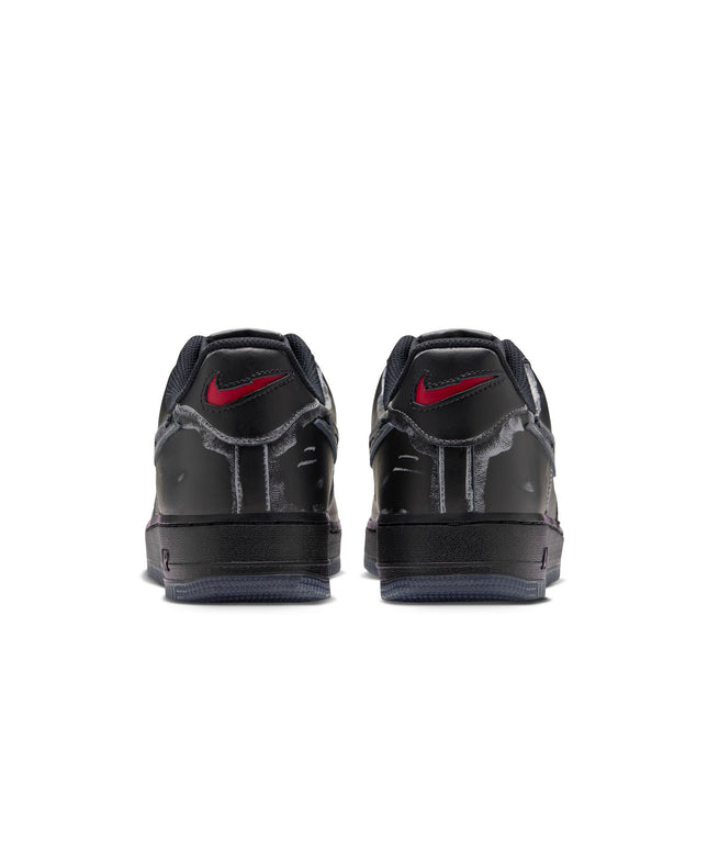 Back view of black leather Nike Air Force 1 '07 Scream sneakers featuring frayed fabric accents and red swoosh logos.