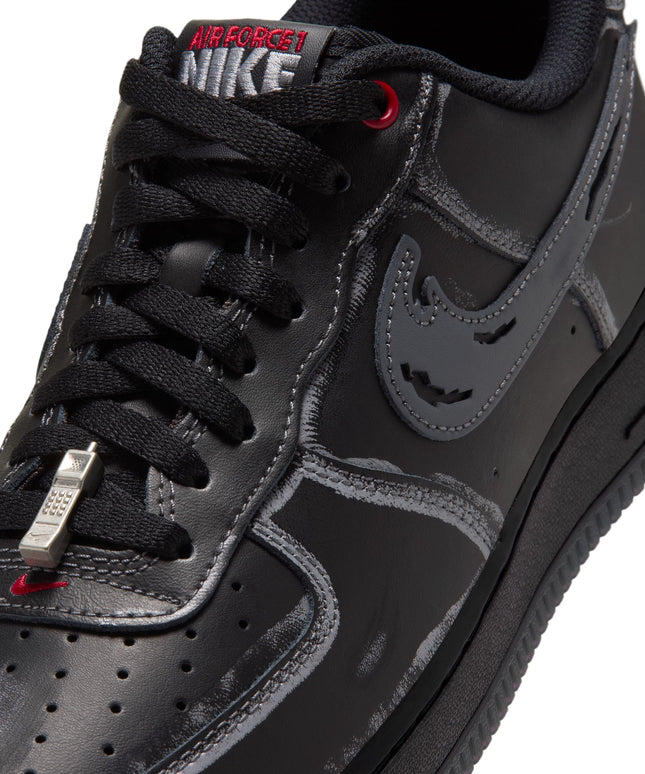 Black leather Nike Air Force 1 '07 sneaker featuring a grey sketched outline, gym red accents, and metallic phone charm.
