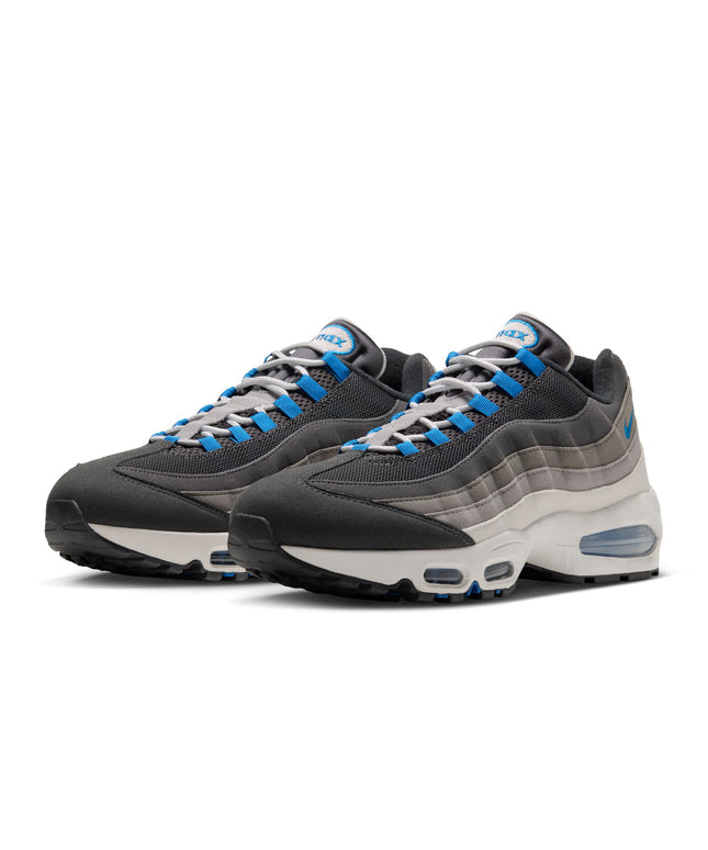 Nike Air Max 95 sneakers in anthracite, grey, and blue, featuring mesh and suede layering with a white foam midsole.