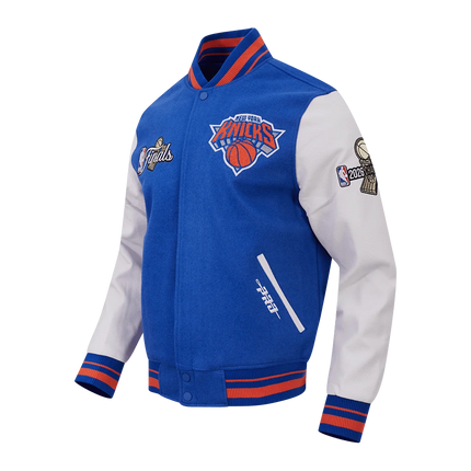 Pro Standard New York Knicks 2026 Champions blue wool varsity jacket with white leather sleeves and embroidered patches.