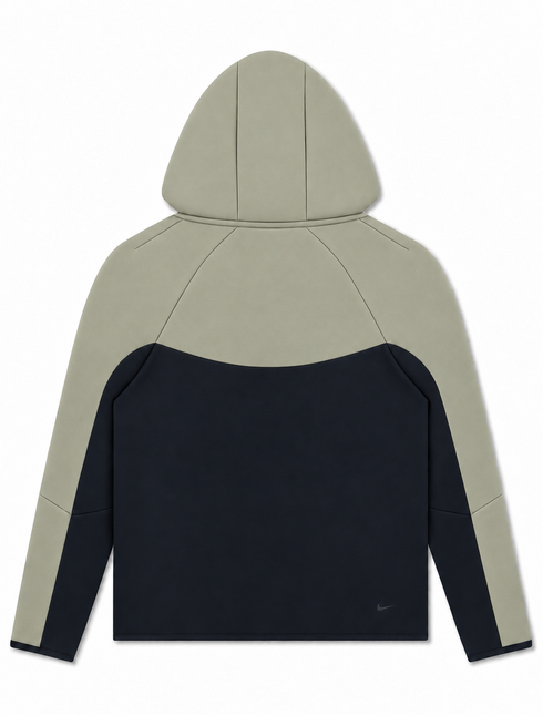 Back view of a Nike Men's Tech Fleece full-zip hooded jacket featuring a two-tone light army and dark navy colorway.