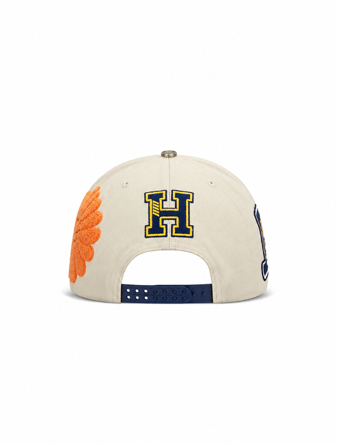 All Human The Cure snapback cap in cream cotton with a navy blue letter H embroidery and a textured orange flower.
