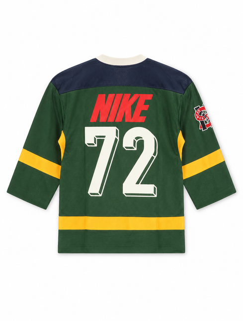 Nike Sportswear Club hockey-style jersey in forest green with navy shoulders, yellow accents, and white 72 graphic.