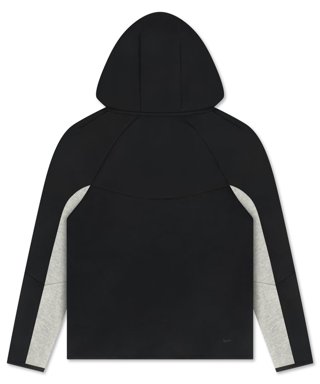 Back view of a black Nike Tech Fleece Windrunner jacket featuring grey heathered panels on the underside of sleeves.