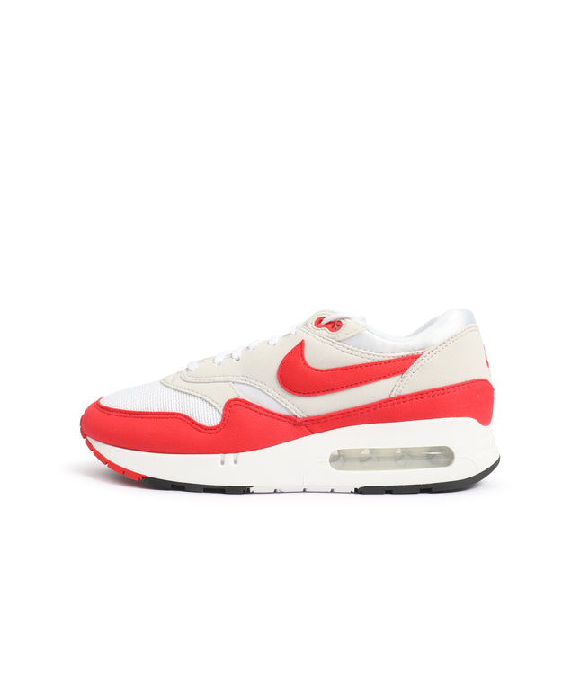 A Nike Air Max 1 sneaker in white and red, shown from a side profile view against a plain white background.