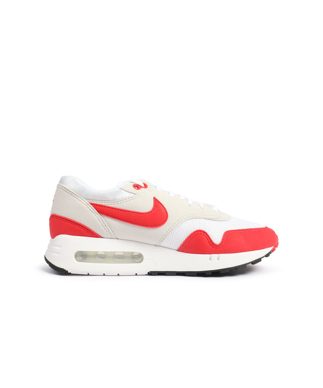 A Nike sneaker in off-white and red, shown from the side profile against a plain white background.