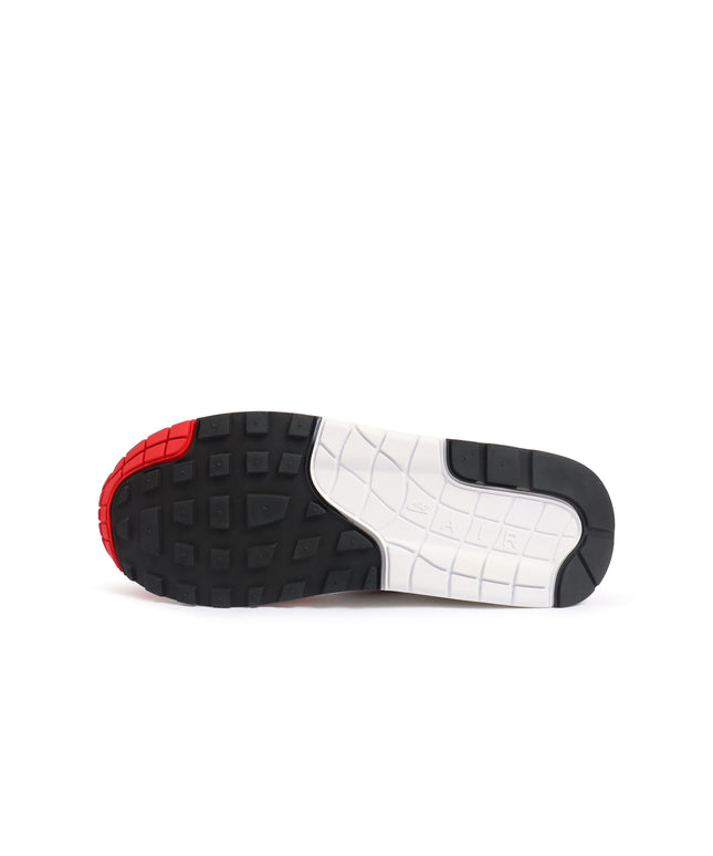 Nike Womens Air Max 1 86 OG outsole featuring a black tread, white midsole, and bright red toe cap on white background.