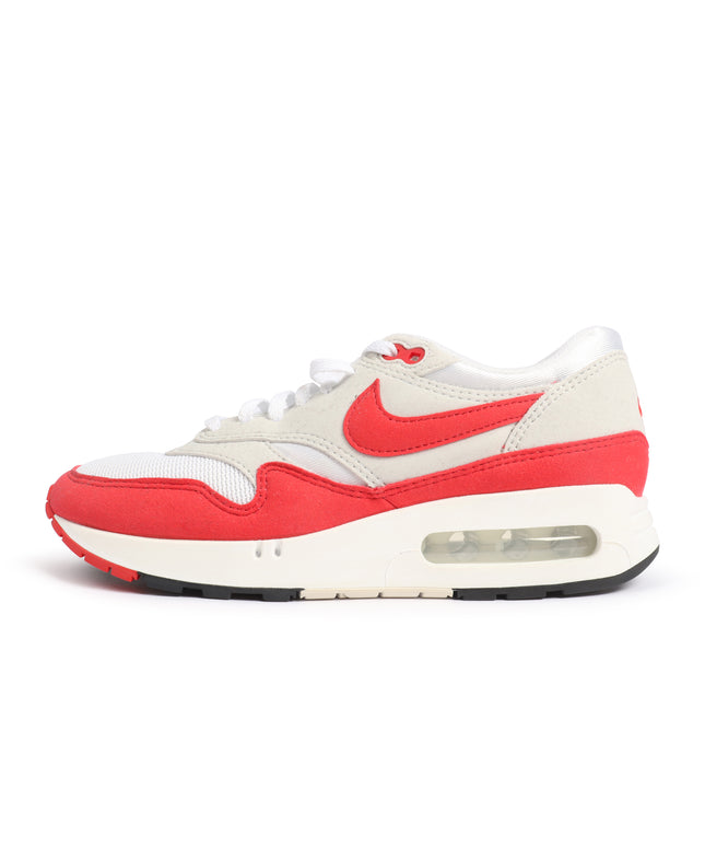 A Nike Air Max 1 sneaker in red, white, and off-white, shown from a side profile view against a plain white background.