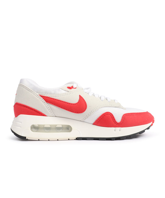 Nike Air Max 1 '86 OG sneaker in white mesh and red suede with a signature side swoosh and visible air cushioned sole.