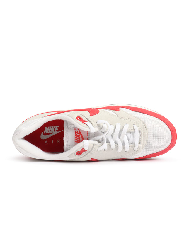 Top-down view of Nike Air Max 1 '86 OG sneakers in white mesh and suede with vibrant university red accents and lining.
