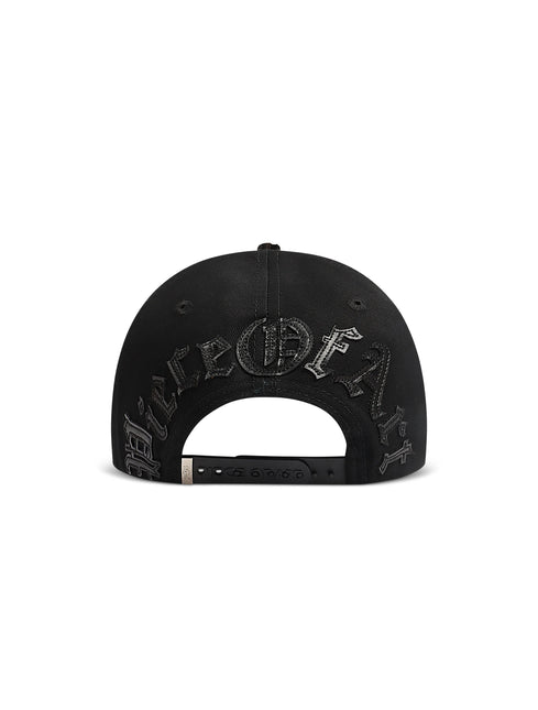 Black Piece Of Art snapback cap rear view featuring embossed distressed gothic text and circular emblem on the back.
