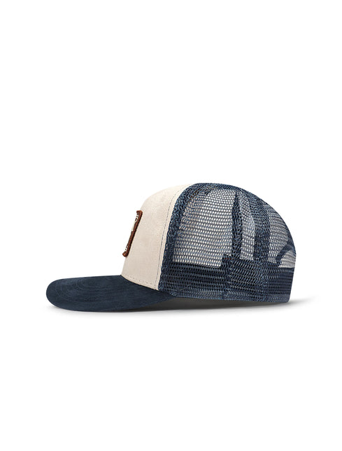 Drunk & Rich trucker hat featuring a cream suede front panel, navy suede brim, and matching navy blue mesh back.