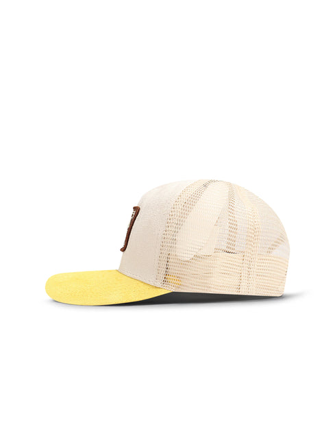 Drunk & Rich trucker hat with a yellow suede brim, cream suede front panel, mesh back, and brown side logo patch.