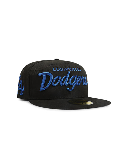 Front view of a black fitted baseball cap with Los Angeles Dodgers script lettering in blue and a blue LA logo on the side.