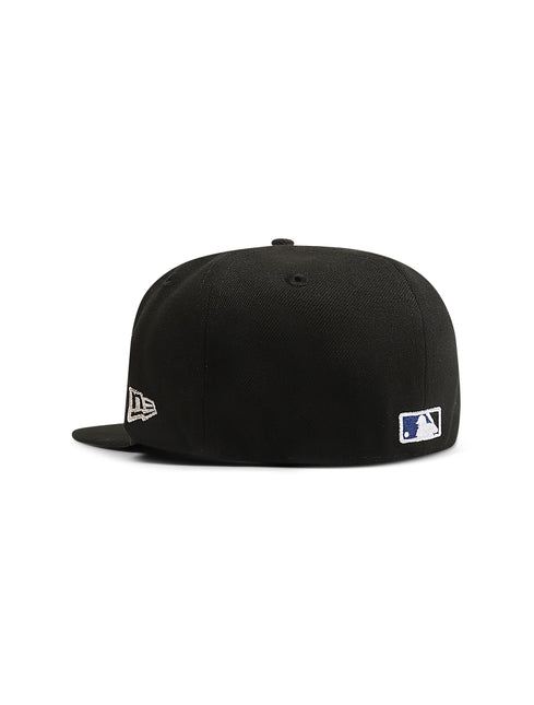 Back view of a black fitted baseball cap with a small MLB logo patch and a New Era logo on the side.