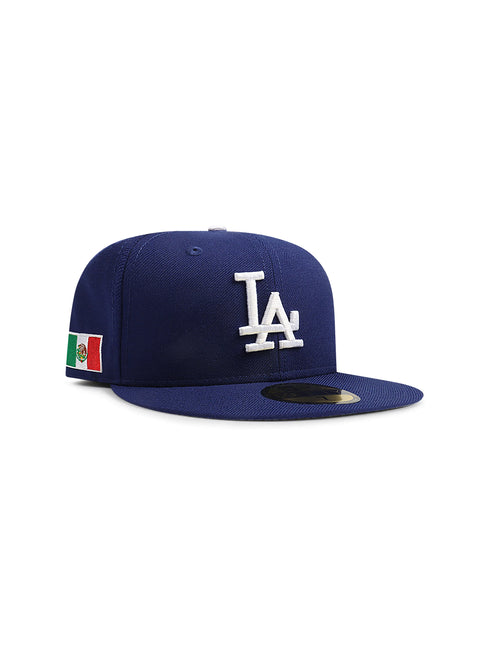 Royal blue New Era 5950 LA Dodgers fitted hat featuring white front logo embroidery and a Mexico flag patch on the side.
