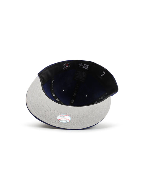 Interior view of a royal blue New Era 5950 LA Dodgers fitted hat showing the grey brim and official MLB holographic tag.