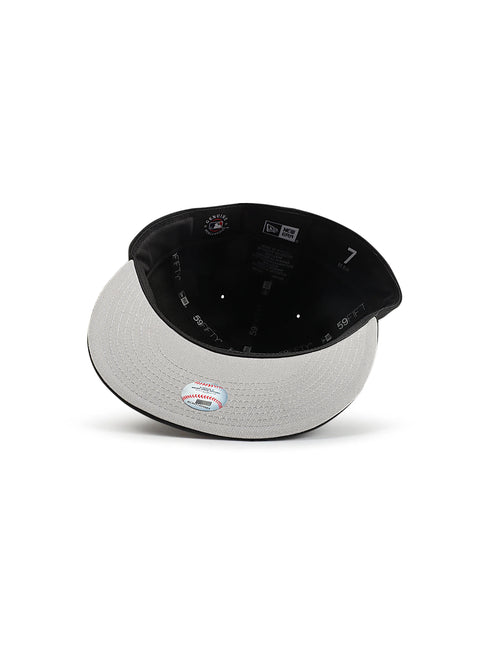 New Era 5950 LA Dodgers fitted hat in black with a light grey undervisor, showing interior branding and size 7 label.