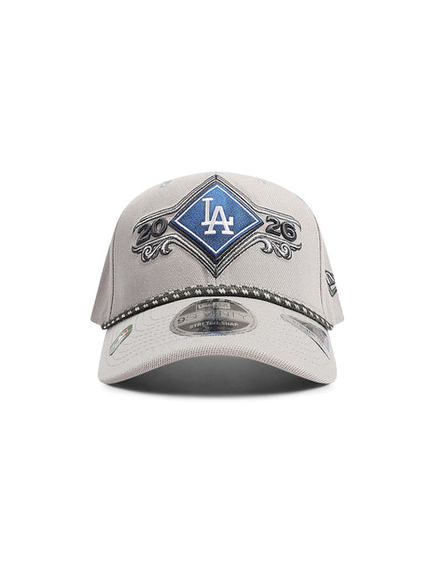 Front view of a light gray baseball cap with a blue diamond LA logo patch and rope trim.