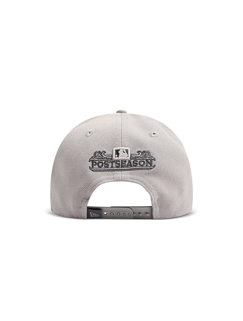 Back view of a light gray baseball cap with a Postseason embroidered patch above the adjustable strap.