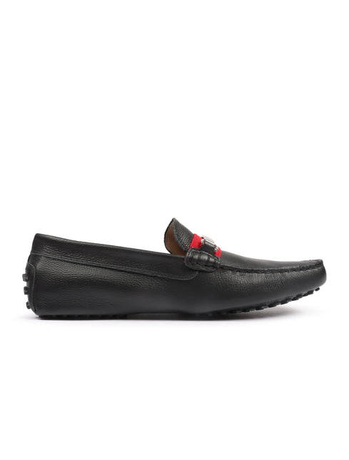 Lacoste black pebbled leather loafer shoe featuring a decorative red and navy fabric strap across the instep.