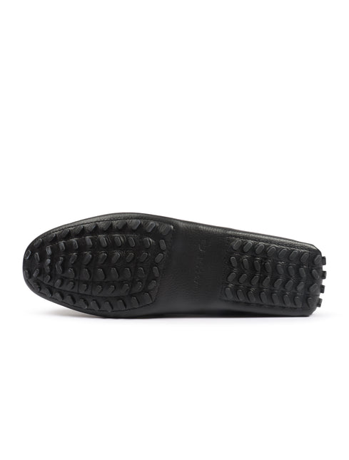 Black Lacoste leather loafer sole featuring a textured pebble grip pattern and embossed brand logo on the midfoot.
