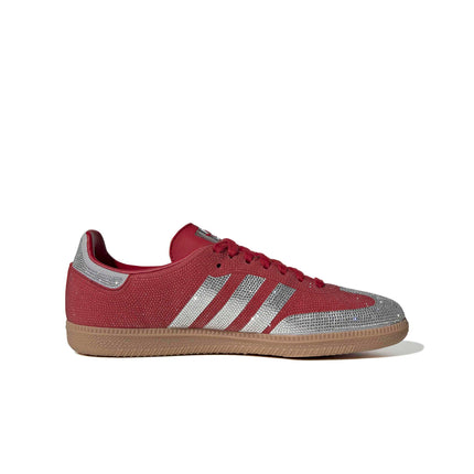Adidas Samba OG women’s sneaker in red featuring crystal-encrusted overlays, silver stripes, and a classic gum sole.
